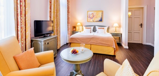 The Schlösschen room with double bed and upholstered armchairs in the Wellness Resort Romantischer Winkel in the Harz Mountains, Bad Sachsa