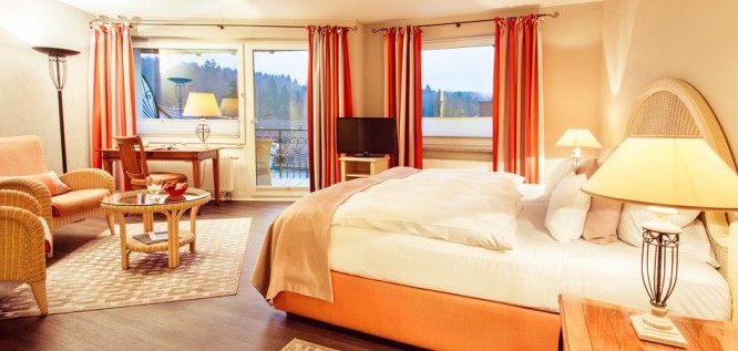 A glimpse to the Toscana room with a view of the lake and forest at the Wellness Resort Romantischer Winkel in the Harz Mountains, Bad Sachsa