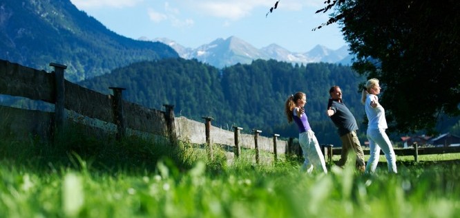 three person doing relaxation exercises in the garden  -  Schuele's Gesundheitsresort & Spa |Allgaeu | Bavaria